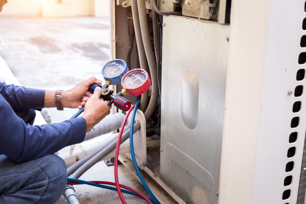 Technician connecting refrigerant gauges