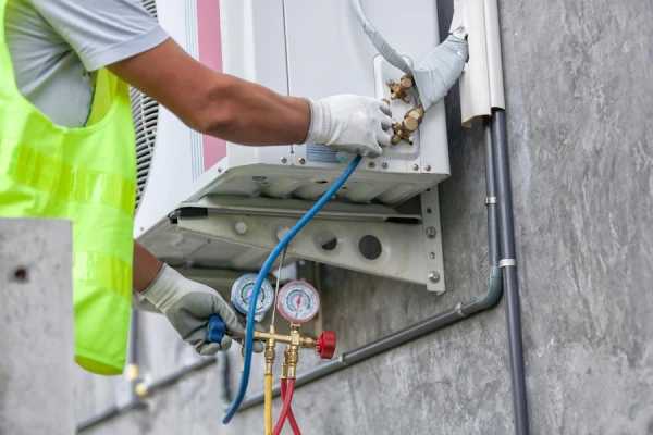 Technician servicing wall AC unit