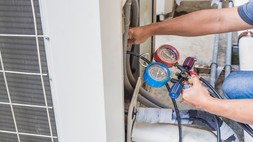 Worker testing air conditioning unit