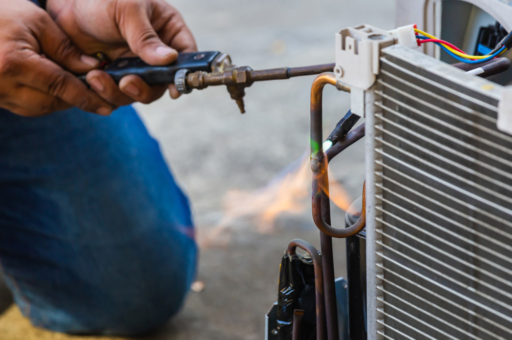 Technician welding air conditioner
