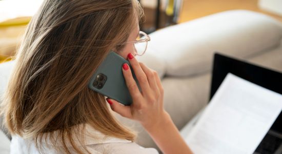 Woman on phone reading document